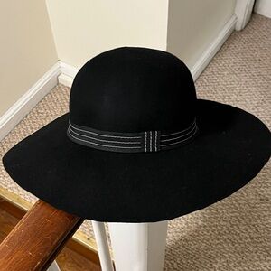 Black wool fedora with black and white seamed ribbon detail.